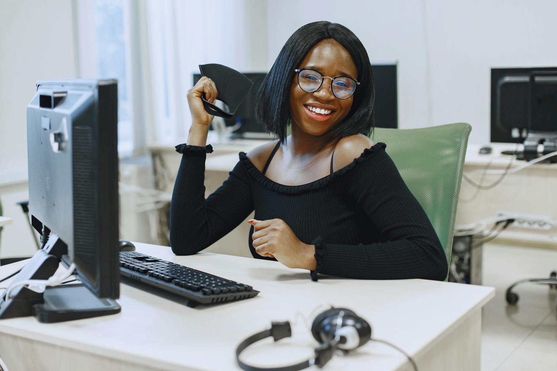 woman in black long sleeve shirt sitting in front of a computer